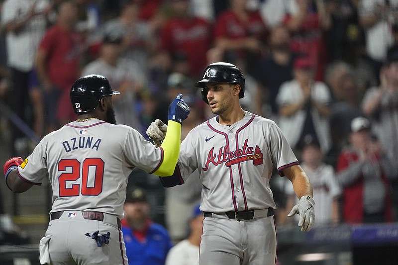 AP photo by David Zalubowski / Atlanta Braves designated hitter Marcell Ozuna, left, congratulates teammate Matt Olson as Olson crosses the plate after hitting a two-run homer in the seventh inning of Saturday night's game against the Colorado Rockies in Denver.