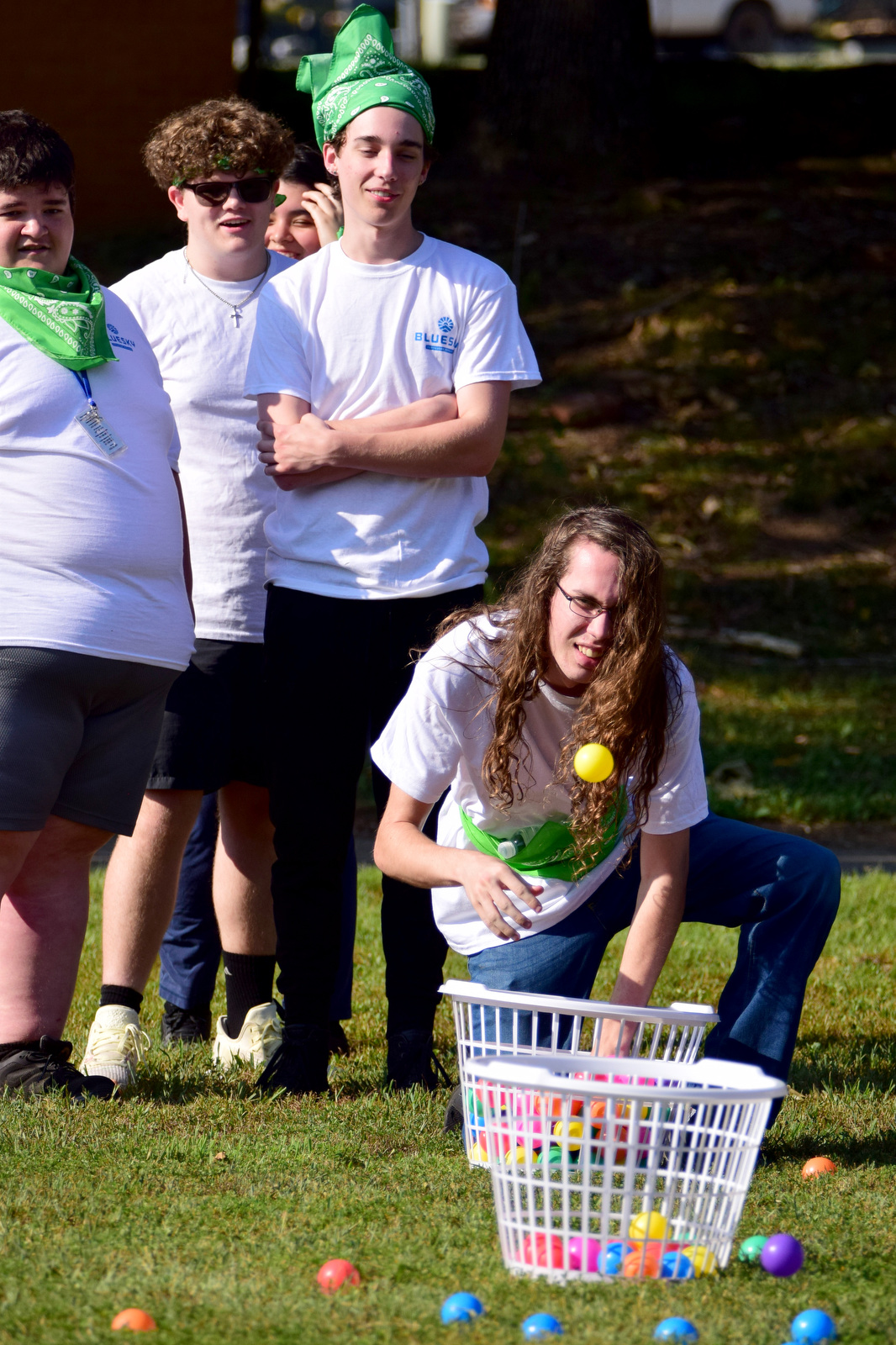 Staff Photo by Robin Rudd / Russell Sanders goes low to lead the green team in the ball toss during a color wars team building exercise at the St. Elmo Recreation Center on Aug. 20, 2024. The BlueSky Institute at BlueCross BlueShield Tennessee is a 27-month tech workforce development program that allows students to obtain a degree, learning from university professionals, and get a job with the company upon graduation.
