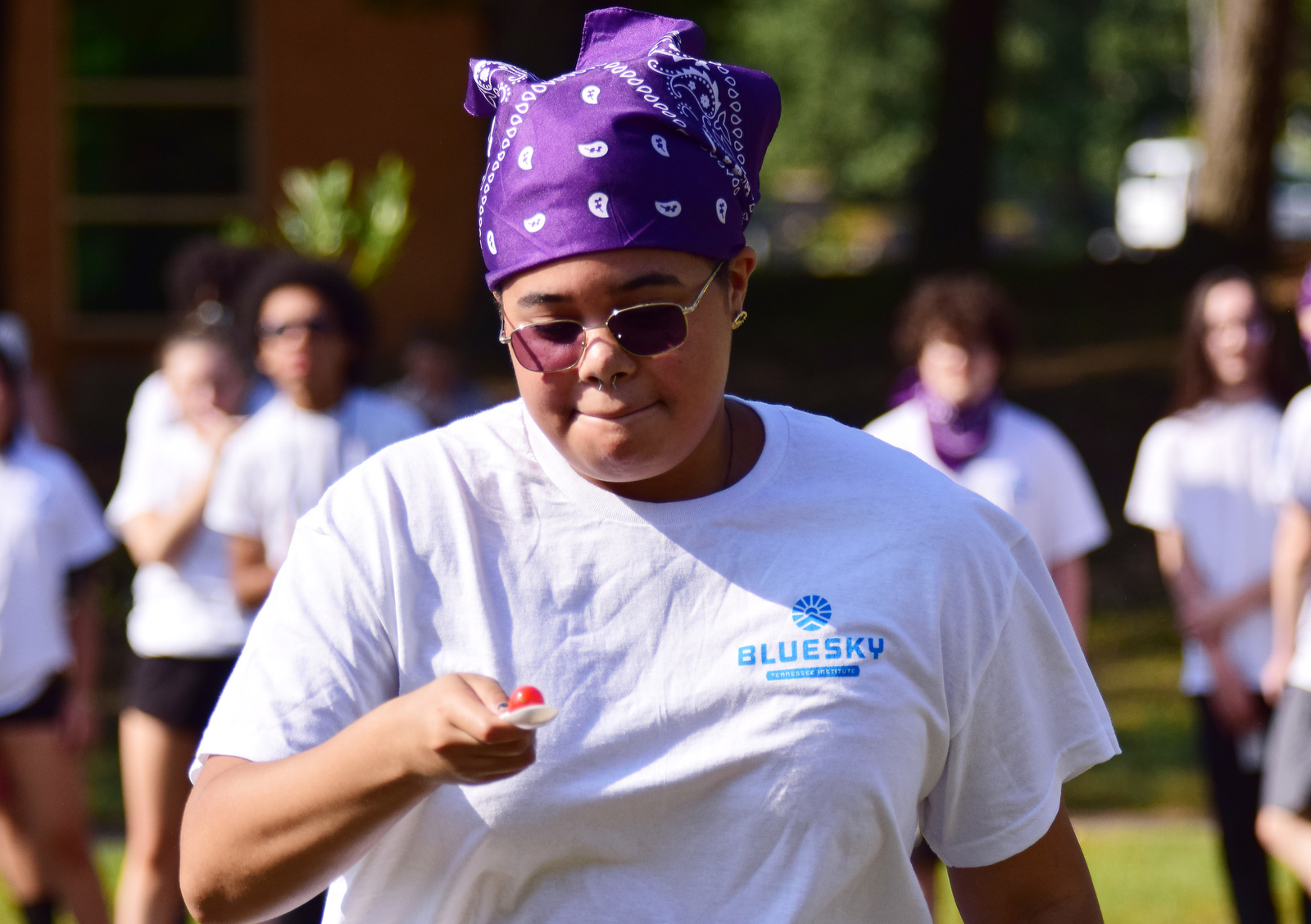 Staff Photo by Robin Rudd / Zee Smith leads the purple team in the tomato relay during a color wars team building exercise at the St. Elmo Recreation Center on Aug. 20, 2024. The BlueSky Institute at BlueCross BlueShield Tennessee is a 27-month tech workforce development program that allows students to obtain a degree, learning from university professionals, and get a job with the company upon graduation.