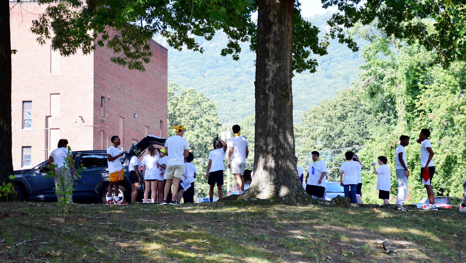 Staff Photo by Robin Rudd / The teams take a break in the shade during a color wars team building exercise at the St. Elmo Recreation Center on Aug. 20, 2024. The BlueSky Institute at BlueCross BlueShield Tennessee is a 27-month tech workforce development program that allows students to obtain a degree, learning from university professionals, and get a job with the company upon graduation.