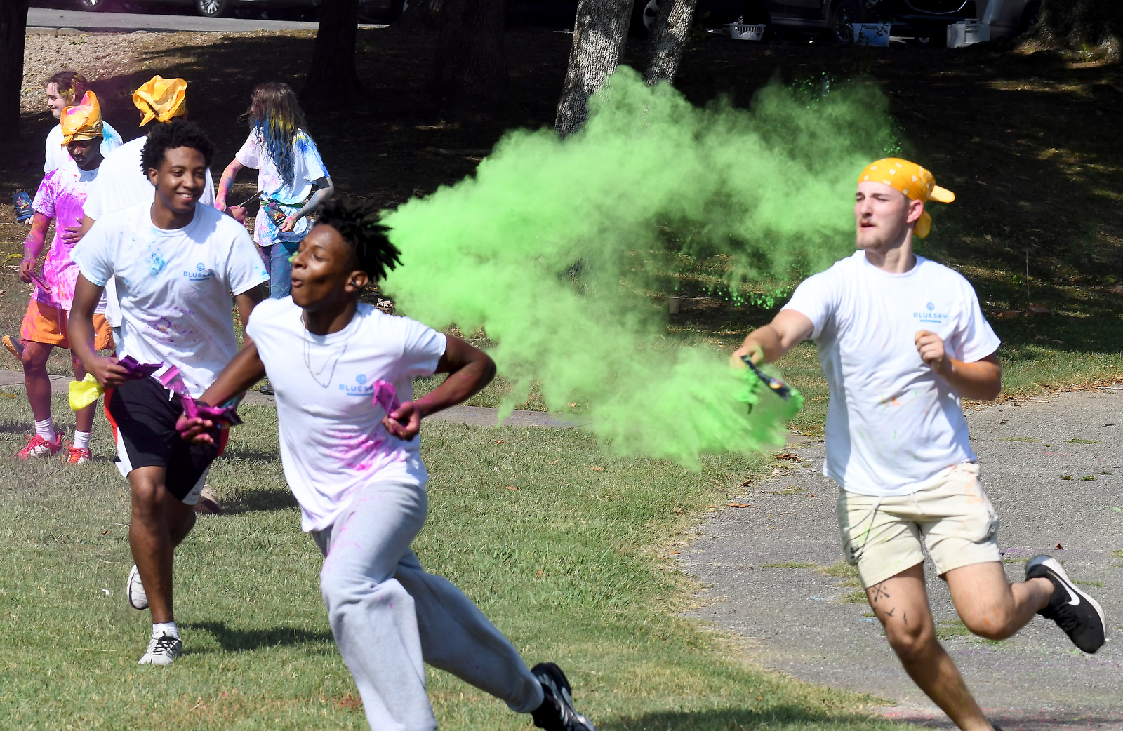 Staff Photo by Robin Rudd / Cameron Higgins escapes the green spray of Shawn Tyler during a color wars team building exercise at the St. Elmo Recreation Center on Aug. 20, 2024. The BlueSky Institute at BlueCross BlueShield Tennessee is a 27-month tech workforce development program that allows students to obtain a degree, learning from university professionals, and get a job with the company upon graduation.