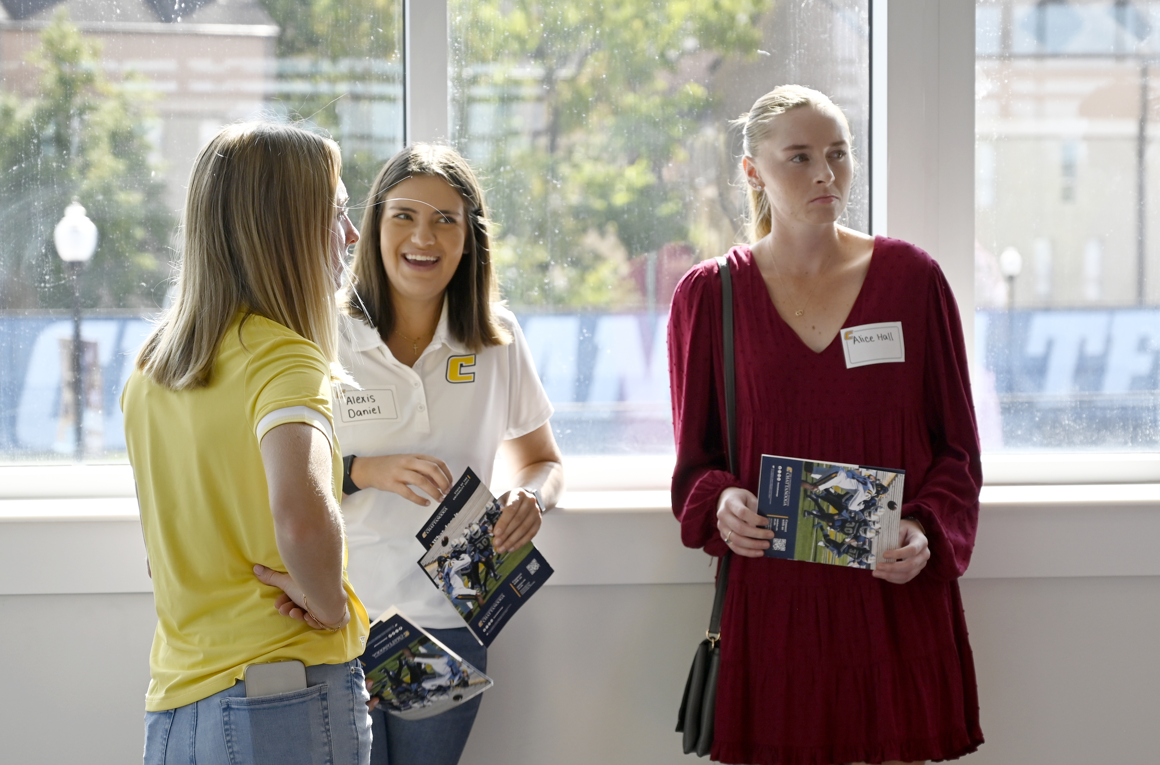 Staff photo by Abby White / Mattie Wall (left), Alexis Daniel (center), and Alice Hall (right) speak prior to the ceremony. UTC Chancellor Steve Angle delivered his annual State of the University Address which also marked the grand opening of the Wolford Family Athletic Center on Monday, September 16, 2024.