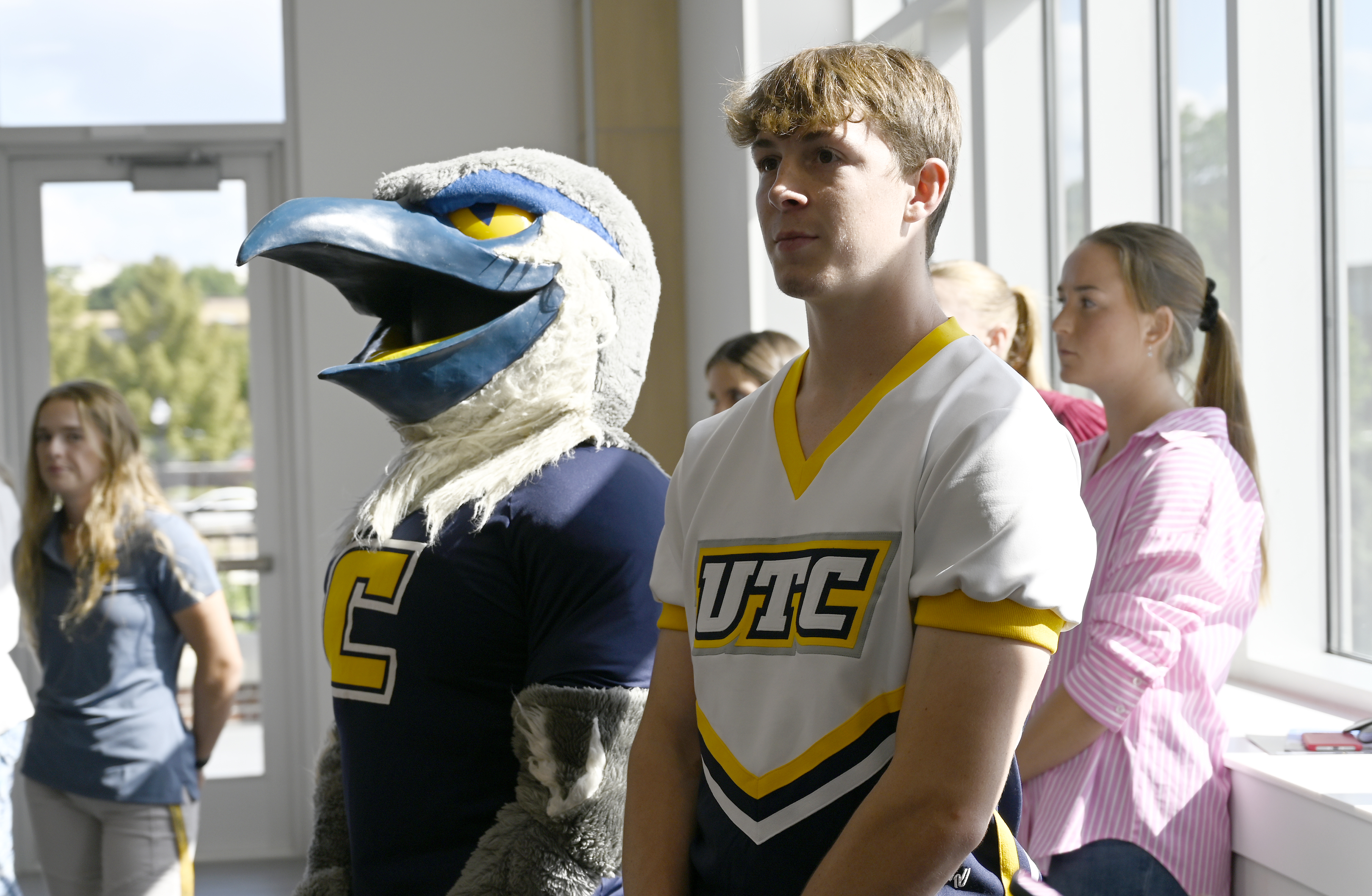 Staff photo by Abby White / Gunner Taylor (right) and Scrappy (left) listen to the State of the University Address. UTC Chancellor Steve Angle delivered his annual State of the University Address which also marked the grand opening of the Wolford Family Athletic Center on Monday, September 16, 2024.