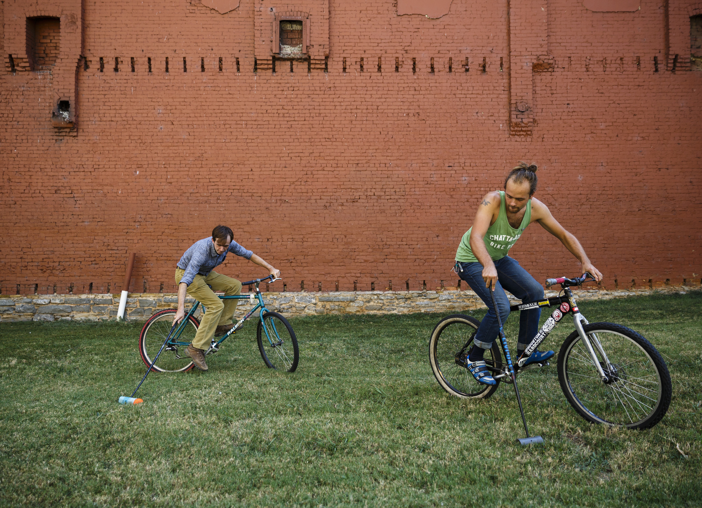 Staff photo / Holden Bitner, right, and Kit Buckley with Chattanooga Bicycle Polo play on Park(ing) Day in 2016. This year's event will be Friday.