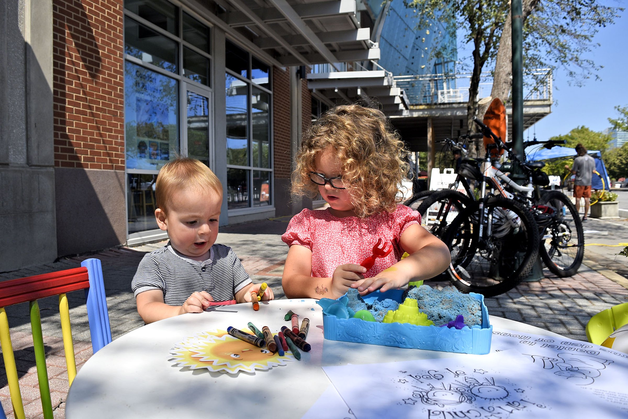Staff Photo by Robin Rudd / Thomas and Hannah Poole play at the Christian Science Reading Room display on Park(ing) Day 2019. The event for this year will be Friday.