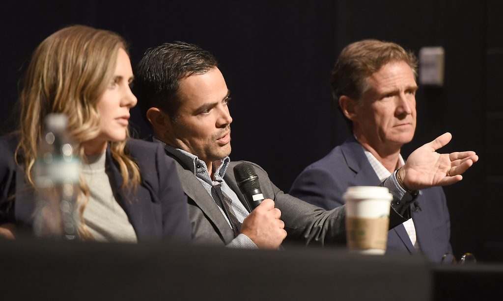 Staff photo by Matt Hamilton / Hamilton County District Attorney Coty Wamp, left, and Chattanooga Mayor Tim Kelly, right, look on as Hamilton County Mayor Weston Wamp speaks during a gun violence summit at Brainerd Crossroads on Tuesday, Oct. 8, 2024.