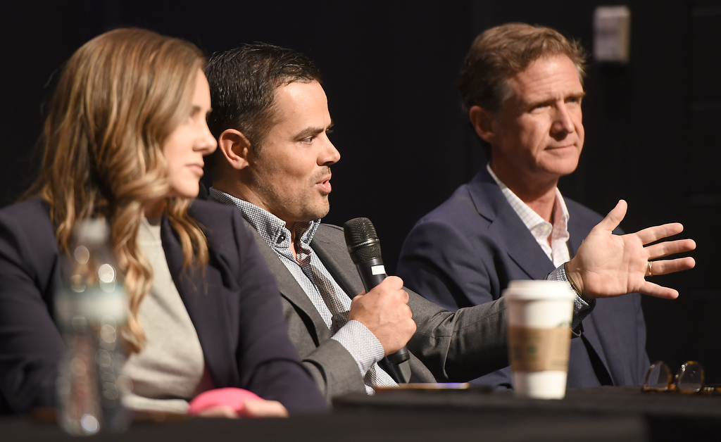 Staff photo by Matt Hamilton / Hamilton County District Attorney Coty Wamp, left, and Chattanooga Mayor Tim Kelly, right, look on as Hamilton County Mayor Weston Wamp speaks during a gun violence summit at Brainerd Crossroads on Tuesday, Oct. 8, 2024.