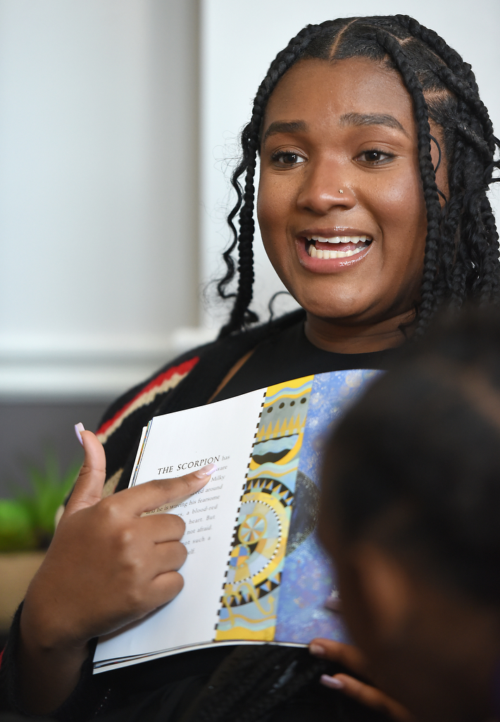 Staff photo by Matt Hamilton / Jasmine Dalton reads a book about constellations Oct. 22, 2024, at Girls Inc. of Chattanooga.
