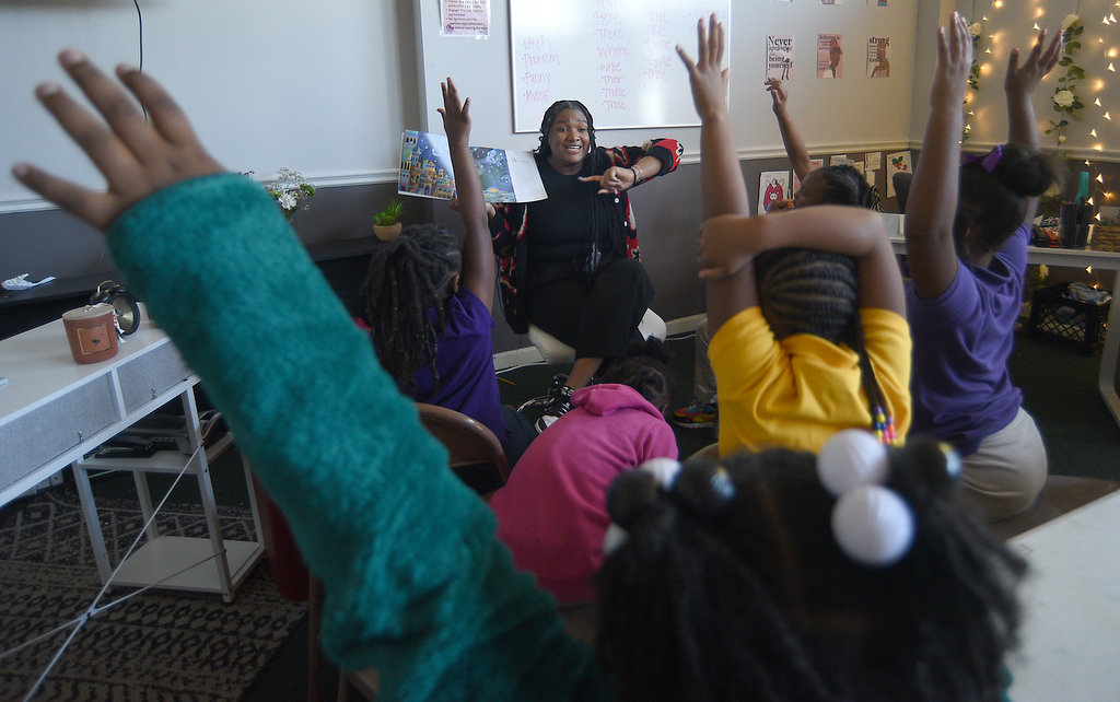 Staff photo by Matt Hamilton / Jasmine Dalton asks a question as she reads a book about constellations Oct. 22, 2024, at Girls Inc. of Chattanooga.