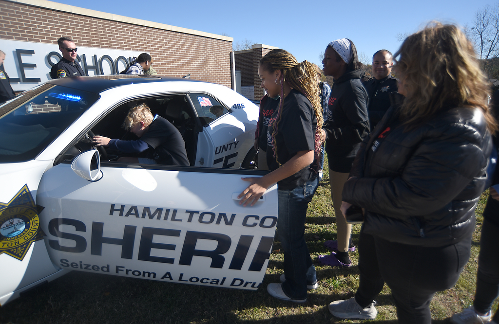 Staff photo by Matt Hamilton / On Nov. 21, 2024, DARE students look over the Hamilton County Sheriff's Office's new DARE vehicle at East Hamilton Middle School.