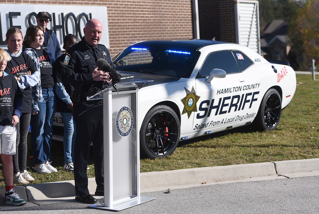Staff photo by Matt Hamilton / Hamilton County Sheriff Austin Garrett speaks Nov. 21, 2024, as a new DARE vehicle is unveiled at East Hamilton Middle School. The car's new paint job includes the phrase