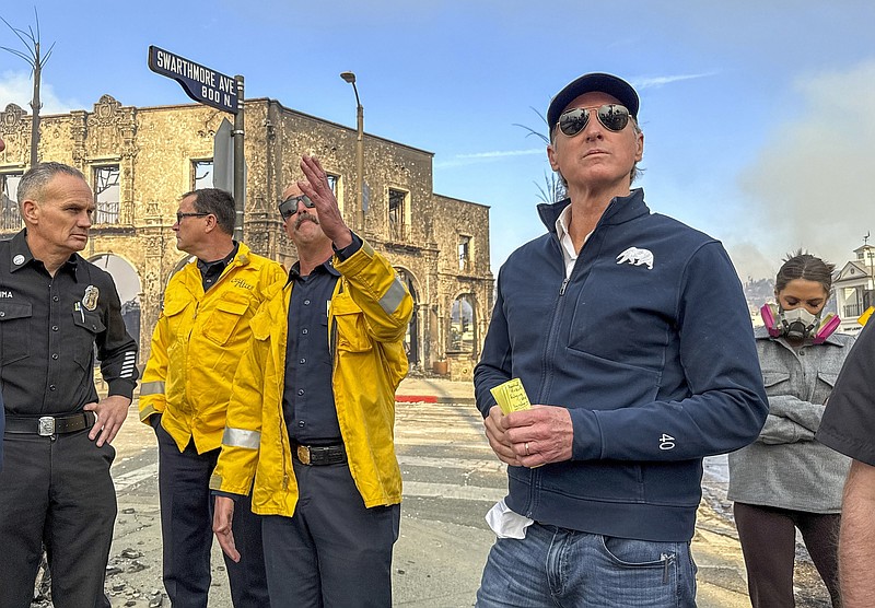 Photo/Jeff Gritchen/The Orange County Register via The Associated Press / California Gov. Gavin Newsom, right, surveys fire damage with CalFire's Nick Schuler on Wednesday, Jan. 8, 2025, in Pacific Palisades, Calif.