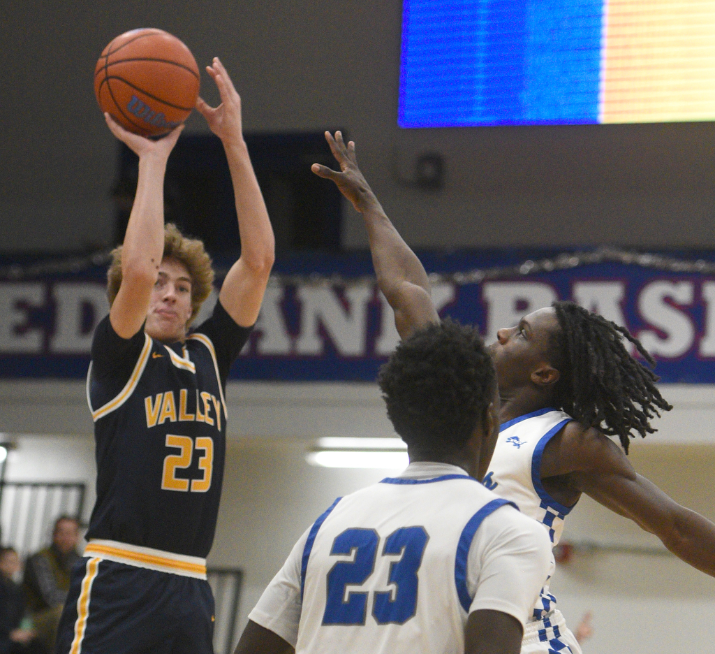 Staff photo by Matt Hamilton/ Red Bank players defend as Walker Valley's Turner Clayton (23) puts up a 3-point attempt during the Mustangs' overtime win at Red Bank Tuesday night.