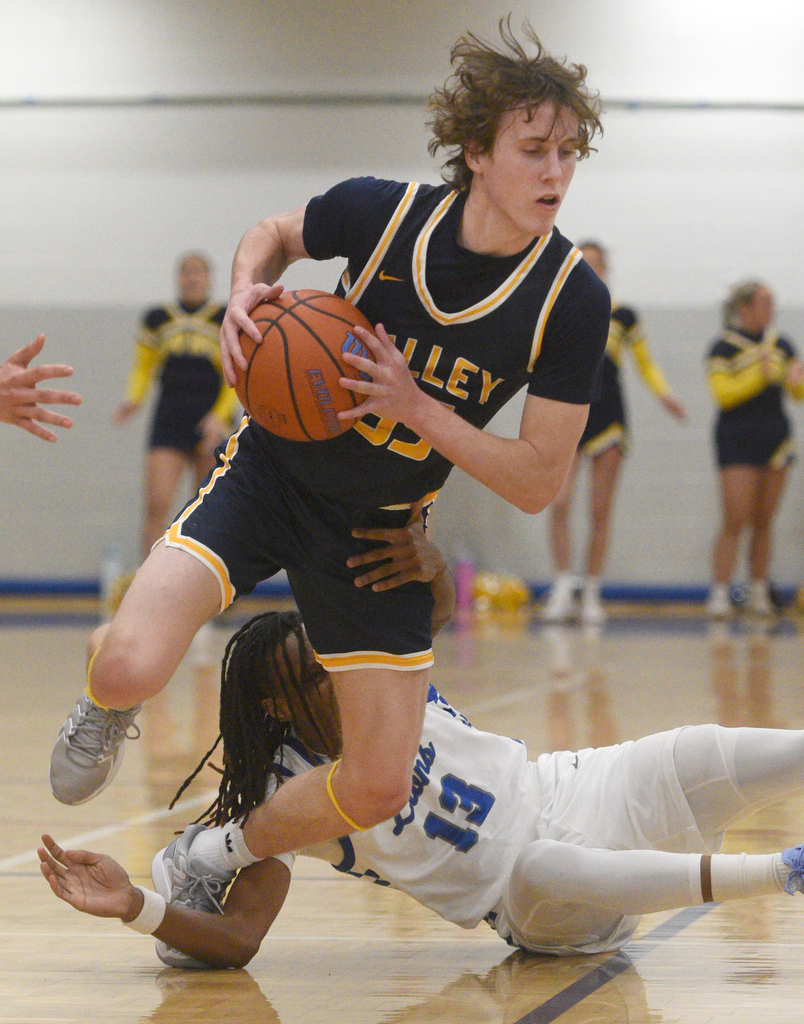 Staff photo by Matt Hamilton/ Red Bank (13) Micah Allen gets wrapped up with Walker Valley (55) Graham Campbell during their game at Red Bank High School on Tuesday, January 21, 2025.