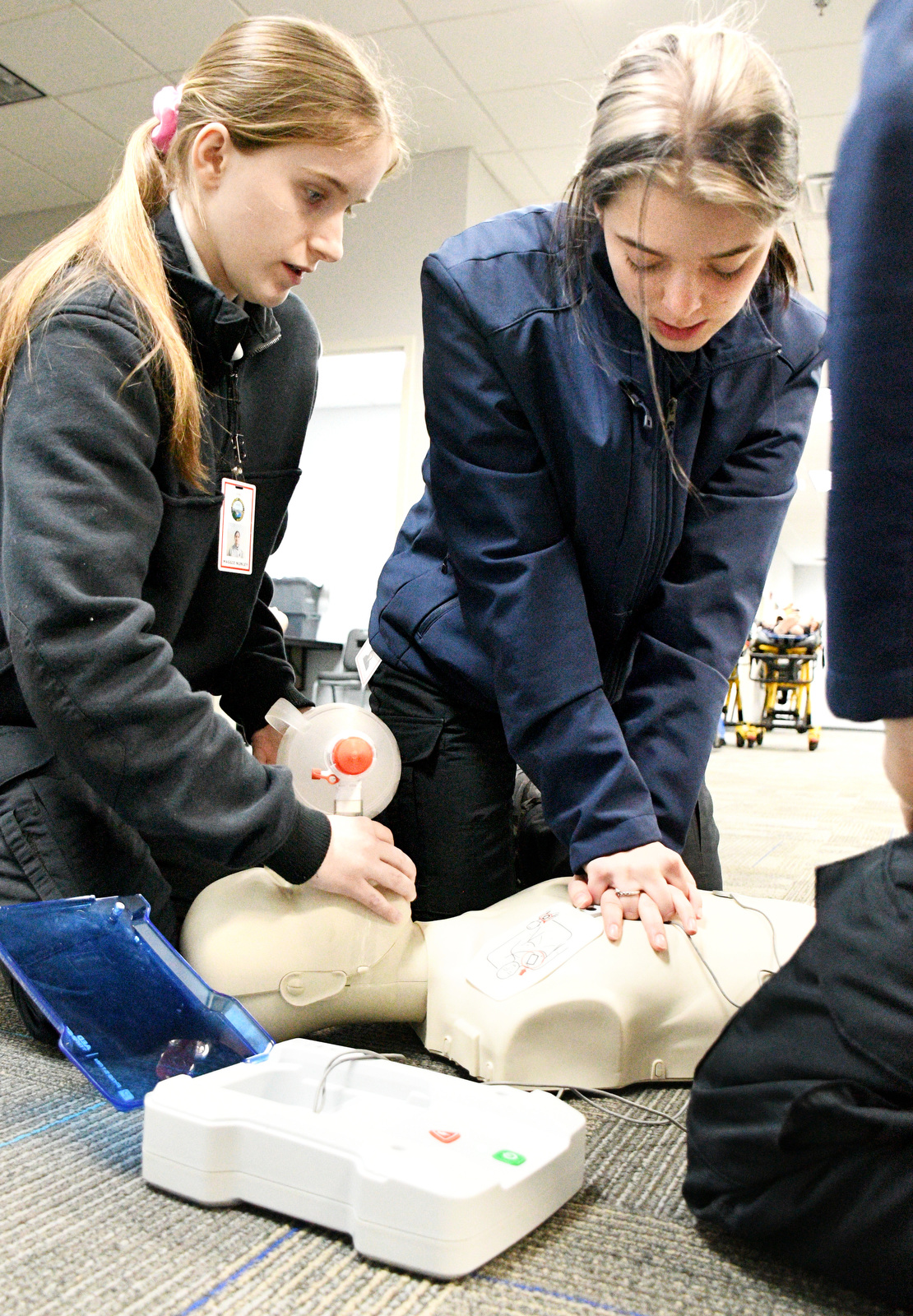 Staff Photo by Robin Rudd / From left, students Maggie Nunley and Abigail Christensen practice CPR with a training manikin Jan. 22, 2025. Starting this school year, Hixson High students can receive hands-on training at Hamilton County's EMS Training Center.
