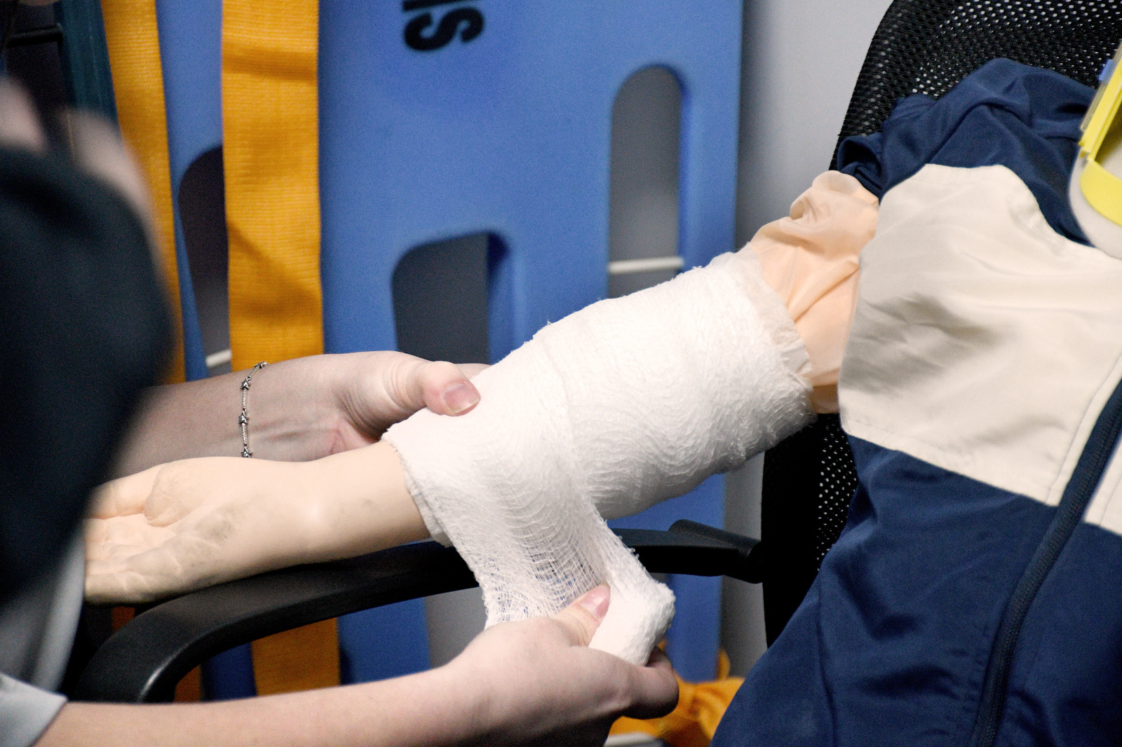 Staff Photo by Robin Rudd / Student Abigail Christensen wraps a pediatric manikin's arm Jan. 22, 2025, during a wound dressing exercise. Starting this school year, Hixson High students can receive hands-on training at Hamilton County's EMS Training Center.