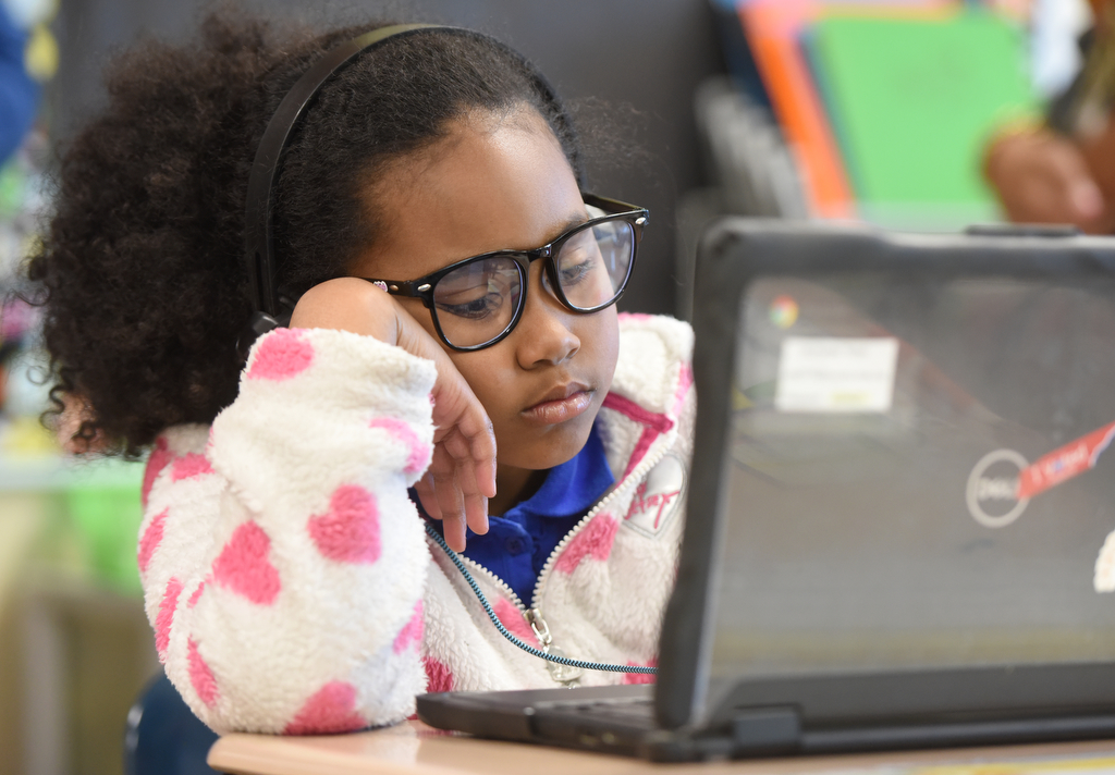 Staff photo by Matt Hamilton/ Paisley Terrell works with a tutor via video chat during a class at Orchard Knob Elementary School on Tuesday, March 11, 2025.