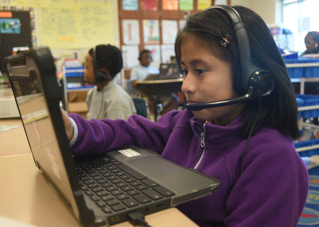 Staff photo by Matt Hamilton/ Victoria Morales Bravo works with a tutor via video chat during a class at Orchard Knob Elementary School on Tuesday, March 11, 2025.