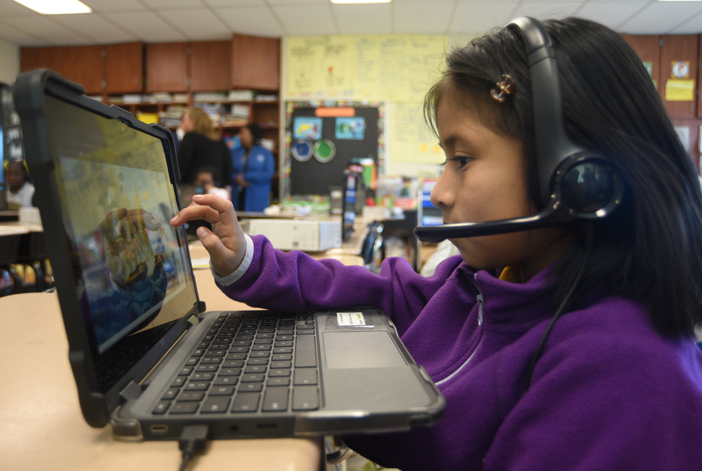 Staff photo by Matt Hamilton/ Victoria Morales Bravo works with a tutor via video chat during a class at Orchard Knob Elementary School on Tuesday, March 11, 2025.