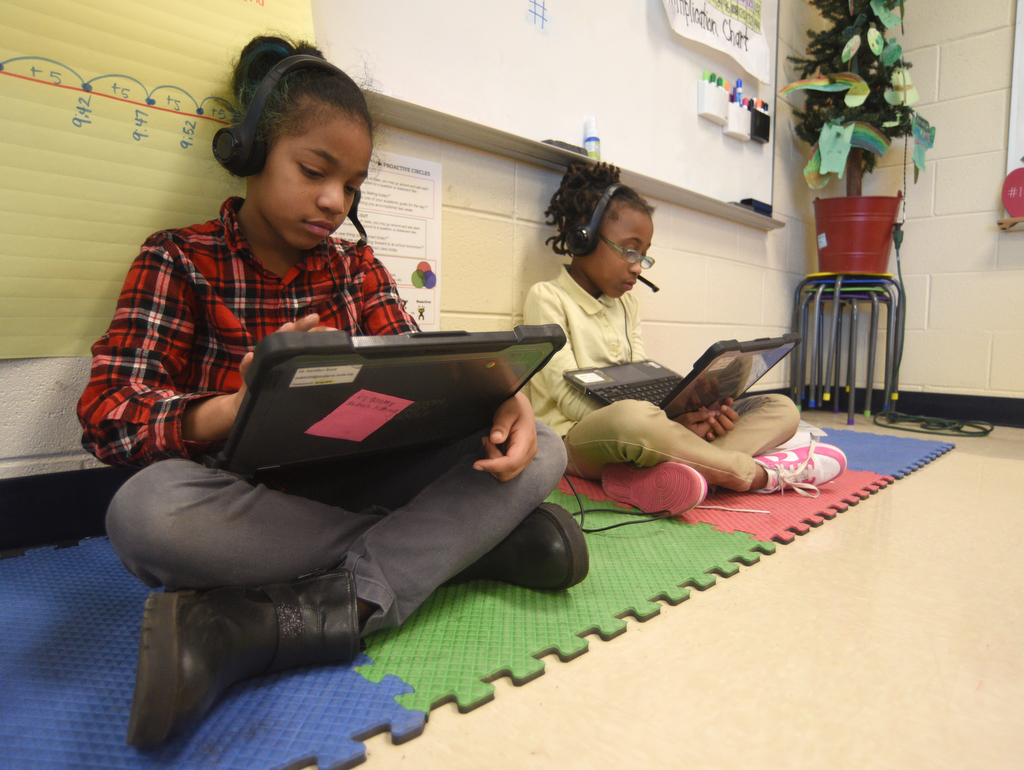 Staff photo by Matt Hamilton/ Kamryn Scott, left, and Brielynn Bridges work with tutors via video chat during a class at Orchard Knob Elementary School on Tuesday, March 11, 2025.
