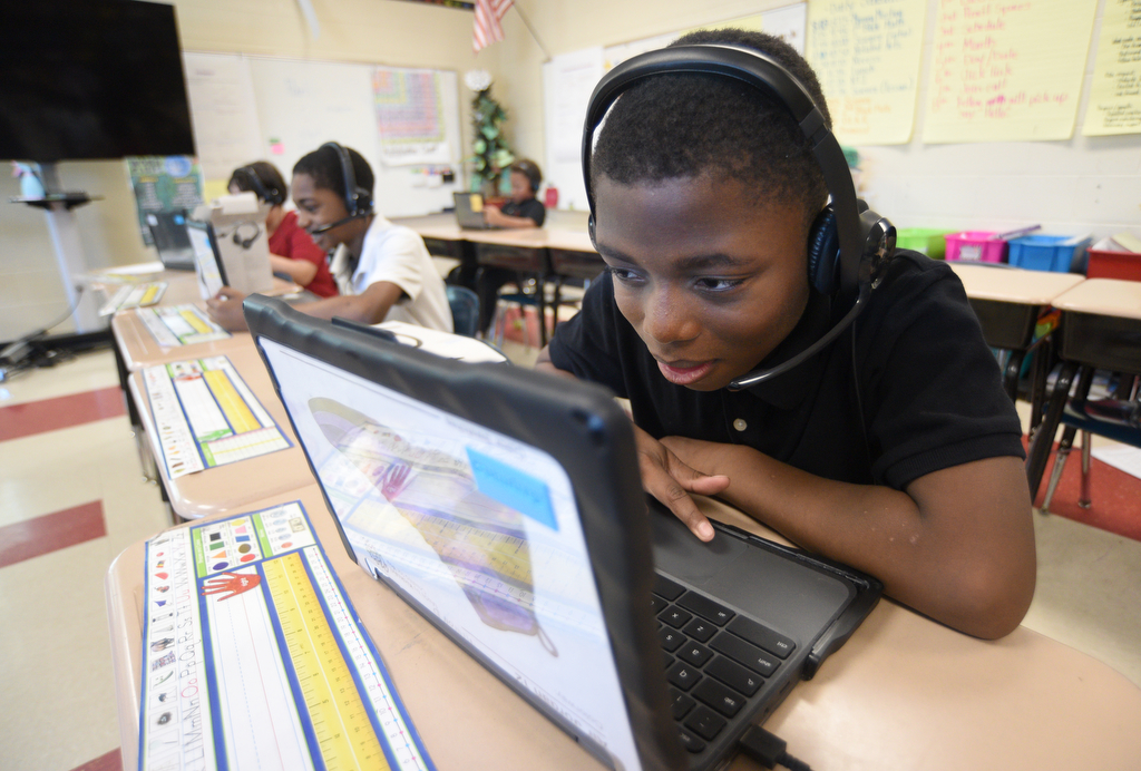 Staff photo by Matt Hamilton/ Kemarion Julks works with a tutor via video chat during a class at Orchard Knob Elementary School on Tuesday, March 11, 2025.