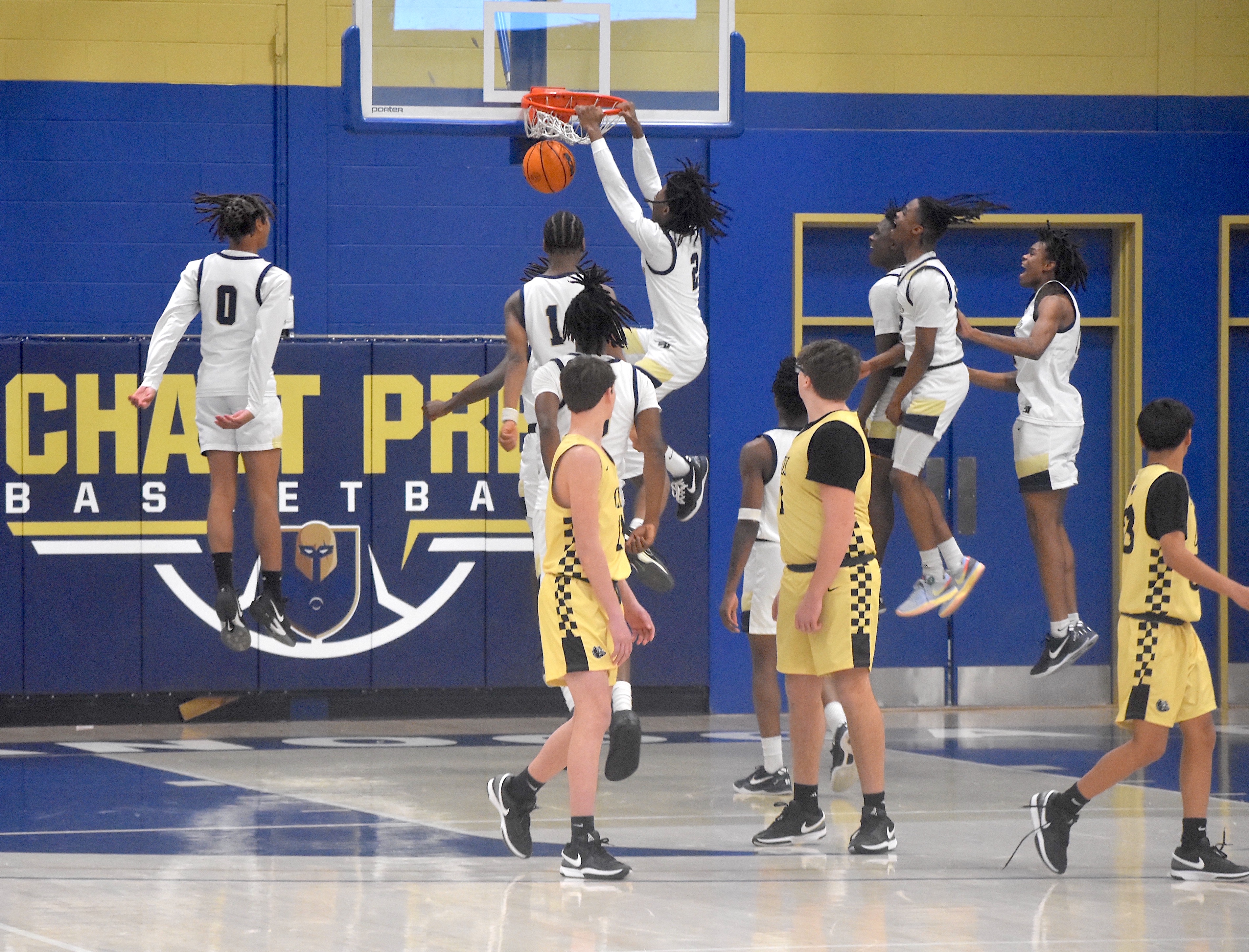 Staff photo by Patrick MacCoon / Chattanooga Prep players celebrate Monday's 71-45 Class 1A sectional home victory over Clay County as Kentrell Watkins throws down a dunk after the final buzzer.