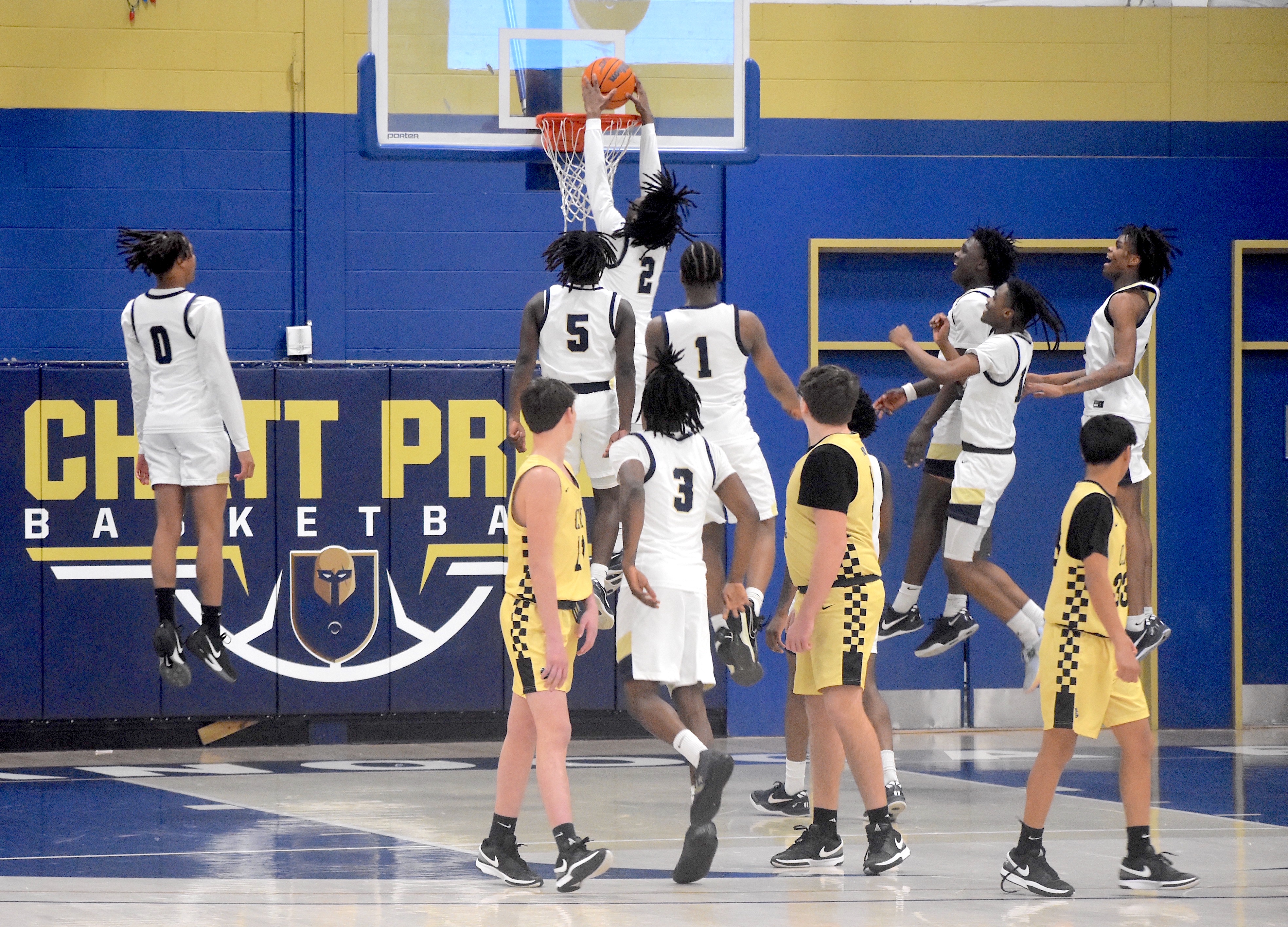 Staff photo by Patrick MacCoon / Chattanooga Prep players celebrate Monday's 71-45 Class 1A sectional home victory over Clay County as Kentrell Watkins throws down a dunk after the final buzzer.