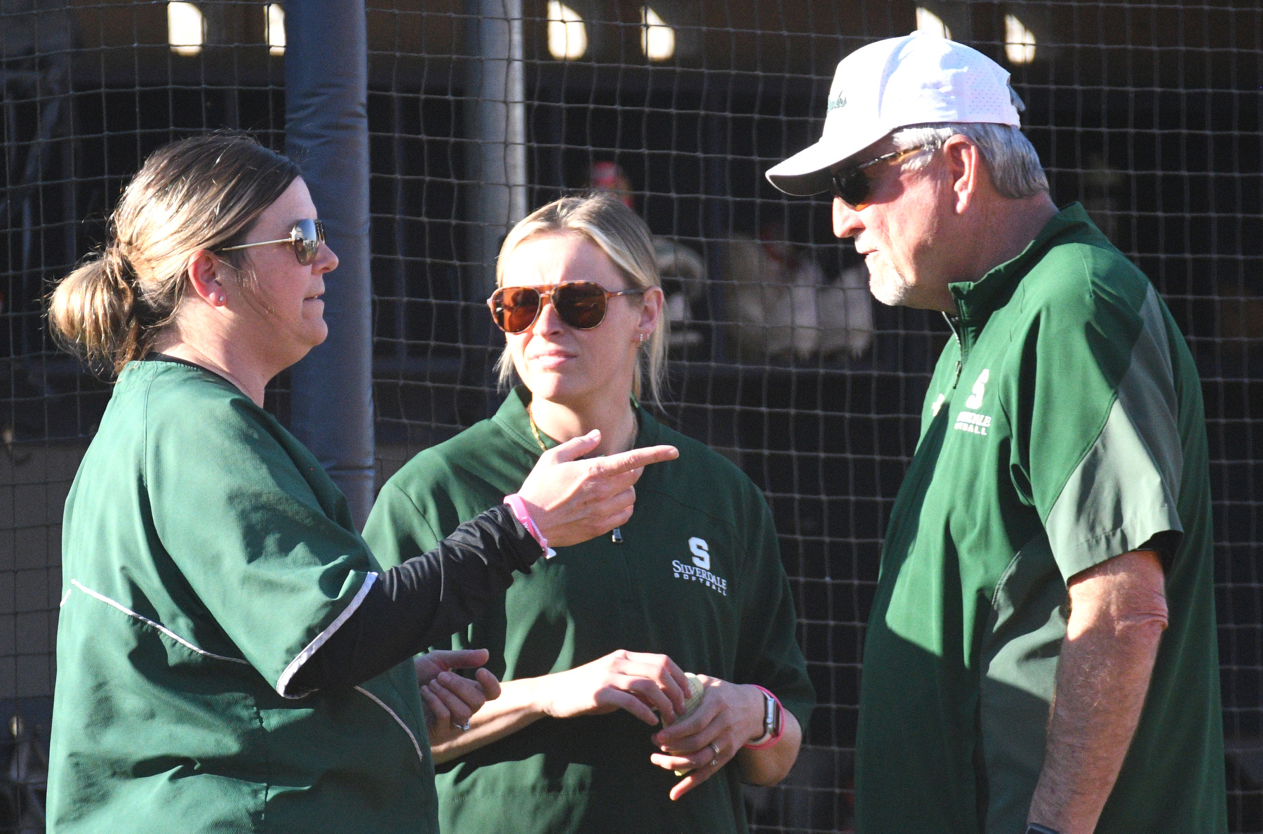 Staff Photo by Robin Rudd / From left, Silverdale head coach Jackie Freeland confers with her assistants, Sloane Mulligan and Tim Thompson. The Chattanooga Christian Chargers hosted the Silverdale Academy Seahawks in a TSSAA softball game on March 11, 2025.
