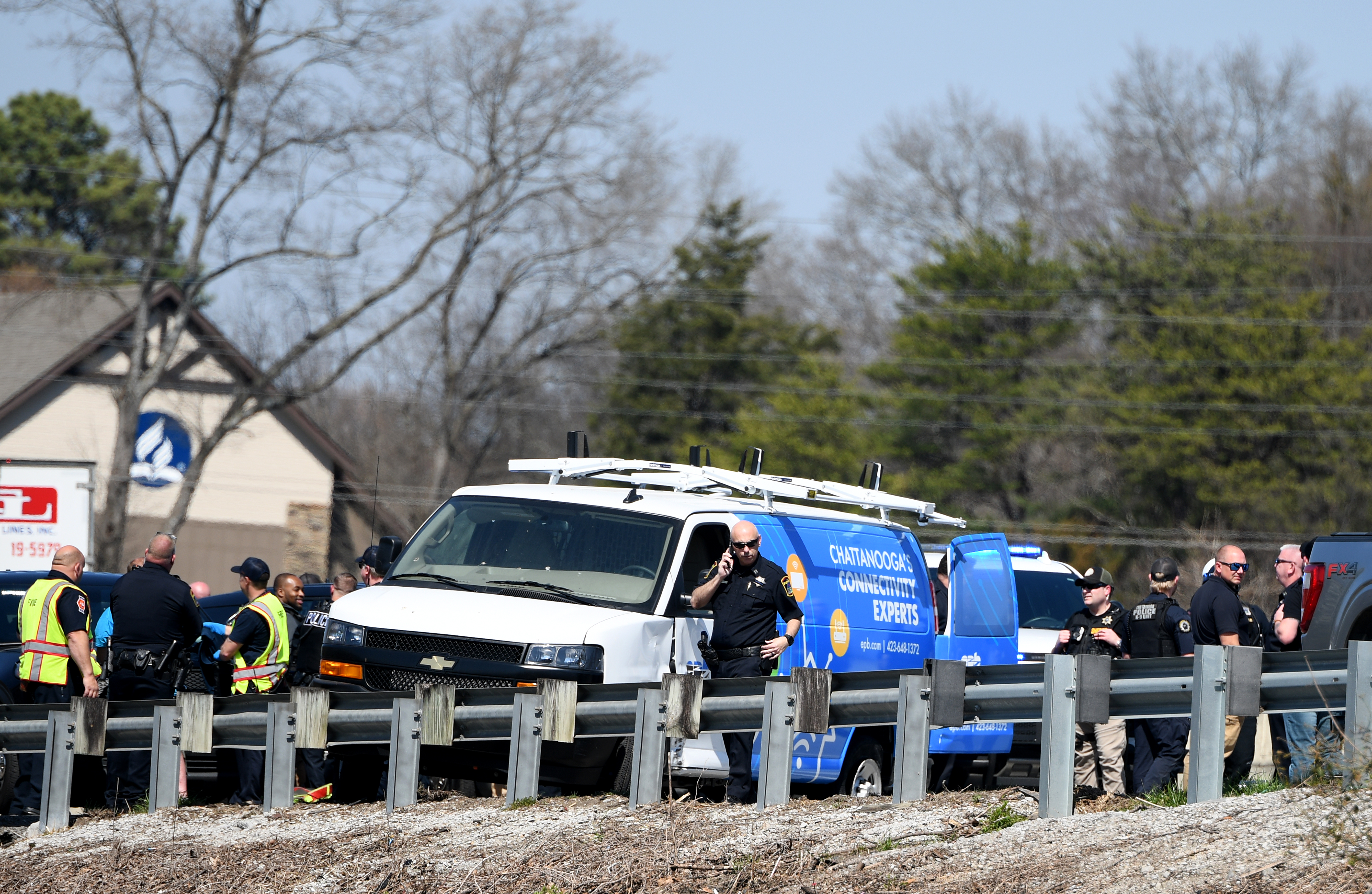 Staff photo by Abby White / Chattanooga police surround a stolen EPB van after a pursuit on Highway 153 near the Bonny Oaks exit March 12, 2025.