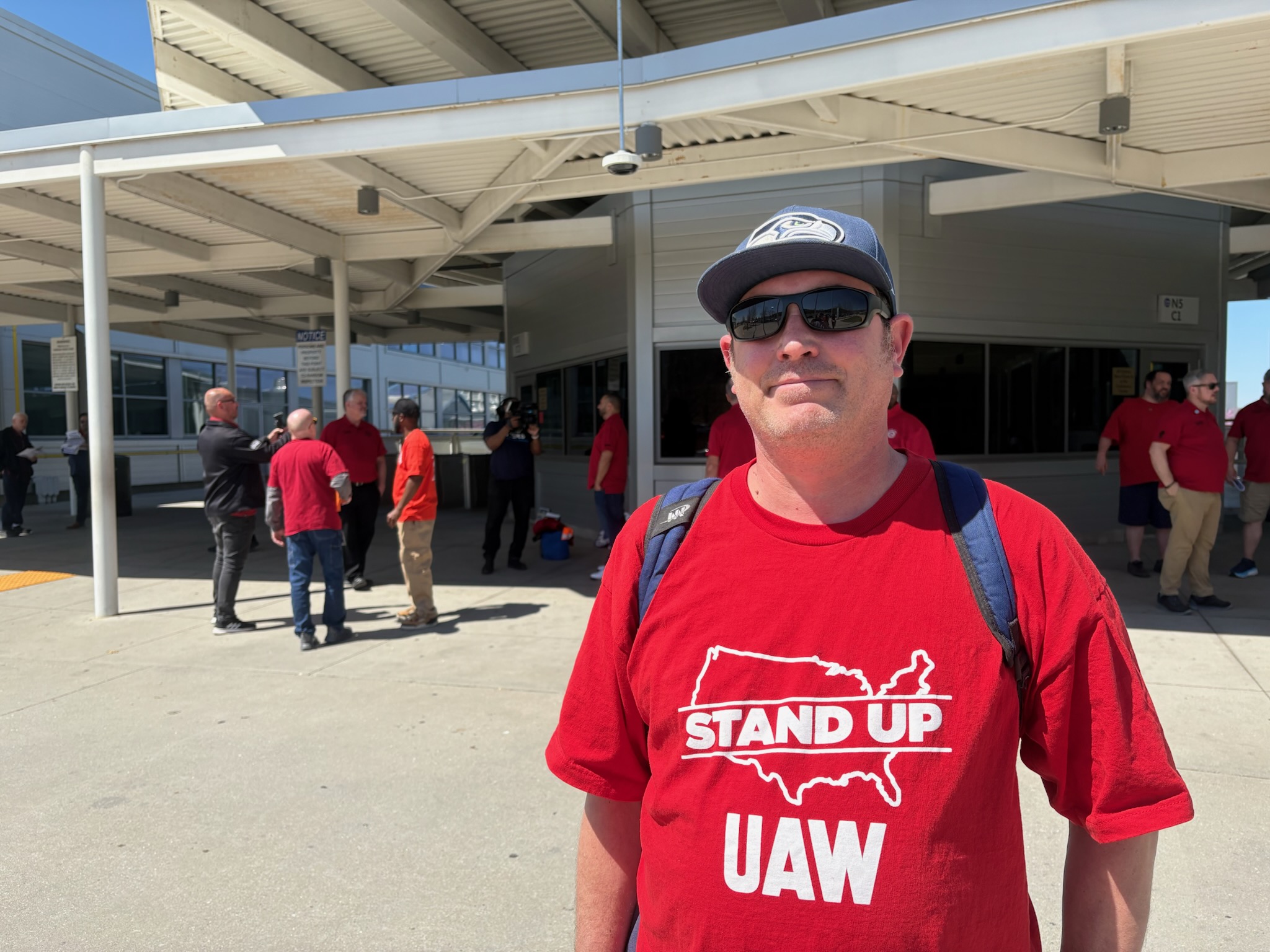 Staff photo by David Floyd / Michael Accetturo, who has worked at Volkswagen in Chattanooga for about two years, stands outside the company's offices during a rally March 26, 2025.