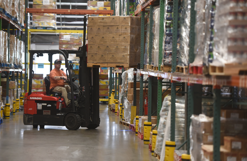 Staff photo by Matt Hamilton/ A worker moves a pallet of food at the Chattanooga Area Food Bank on Friday, April 4, 2025.