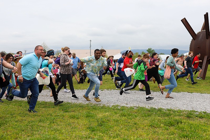Staff file photo / Participants in a previous Great Adult Egg Hunt race to find eggs hidden at the Sculpture Fields at Montague Park. This year's event, presented by The Chattery, is April 19. The hunt and related activities will be followed by Hoppy Hour at OddStory Brewing on Central Avenue.