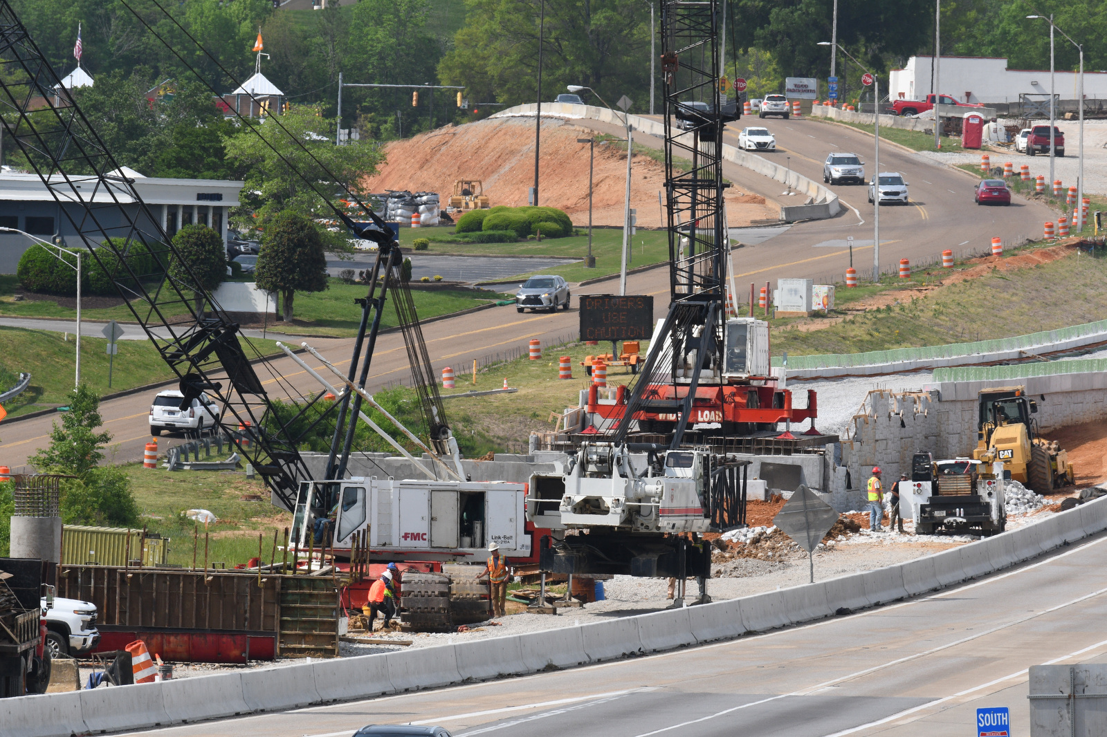 Staff Photo by Robin Rudd / Work continues April 20, 2025, on Interstate 75 near Hamilton Place. The week of April 21-25 is Work Zone Awareness Week in Tennessee. Drivers are reminded to watch for work zone speed limits and move over or slow down when encountering emergency or utility vehicles on the roadside.