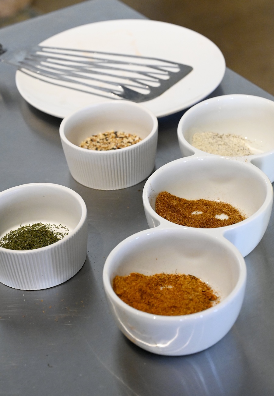 Staff photo by Abby White / Party Bites chef Antonio Tate uses various seasonings for his chai bourbon glaze.