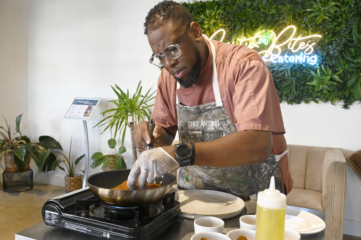 Staff photo by Abby White / Party Bites chef Antonio Tate blackens a seasoned salmon fillet.