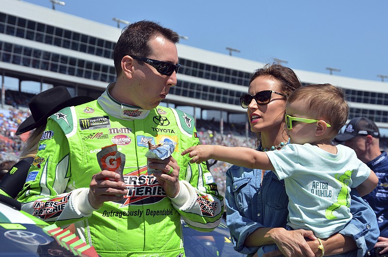 AP photo by Randy Holt / NASCAR driver Kyle Busch jokes with his son Brexton as he talks with his wife Samantha on pit road at Texas Motor Speedway before a Cup Series race in Fort Worth on April 9, 2017.