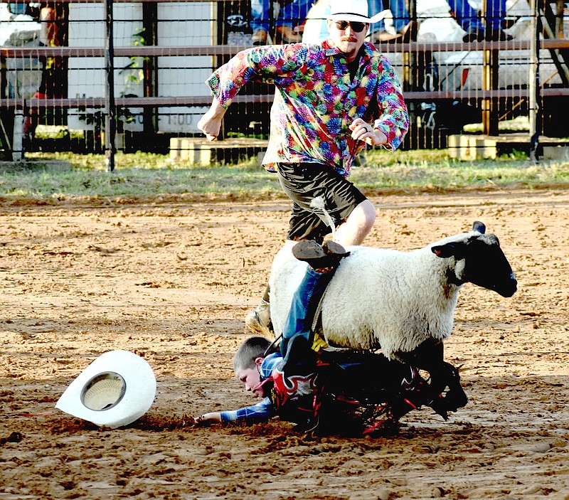 MARK HUMPHREY  ENTERPRISE-LEADER/Junior cowboy Dax Ketzler got hung up during Friday's Mutton Busting, but he was OK scoring 78 points the hard way.