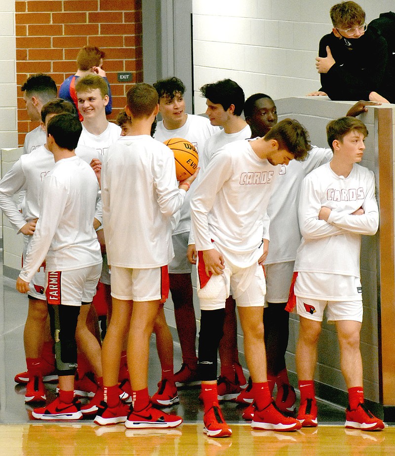 MARK HUMPHREY  ENTERPRISE-LEADER/Farmington's varsity boys basketball team waits for a girls game to finish before coming out on the hardwood to warm up. The Cardinals defeated the Future School of Fort Smith, 72-28, in nonconference action at home in Cardinal Arena on Nov. 13.