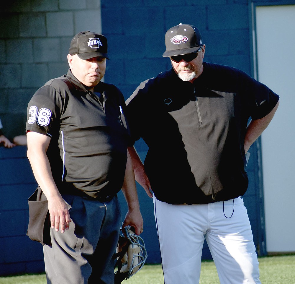 MARK HUMPHREY ENTERPRISE-LEADER/Huntsville baseball coach Greg Harris (left), shown seconds after a vigorous protest contesting an infield single by Farmington's Tate Sutton in the fifth inning, did not debate a "balk" ruling in the top of the seventh that occurred prior to contact made by the Eagles' Luke Eaton erasing a base hit and potential RBI that would have put Huntsville ahead. With the "balk ruling" enforced a fly ball on the next pitch ended the inning and the game remained tied 4-4. Farmington eventually won 5-4 walking in a run with the bases loaded in the ninth.