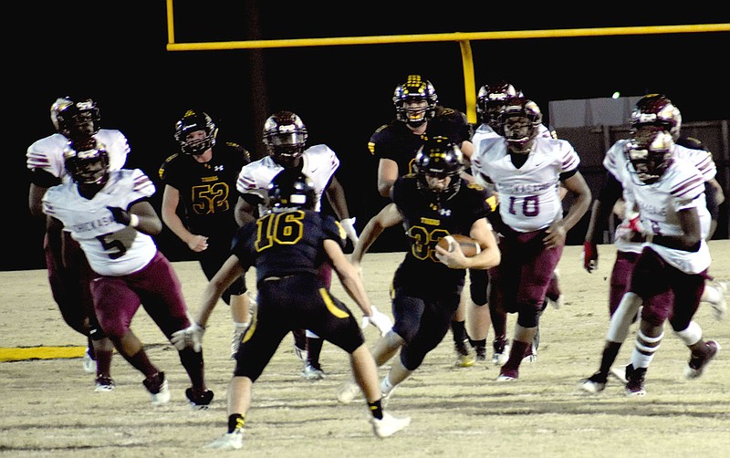 MARK HUMPHREY  ENTERPRISE-LEADER/Prairie Grove senior fullback Foster Layman side-steps teammate Ethan Miller, who blocked one of the Blytheville defenders in pursuit. Layman rushed 14 times for 121 yards including this 52-yard touchdown carry playing a major role in Prairie Grove's 59-34 Class 4A playoff win over Blytheville on Friday.