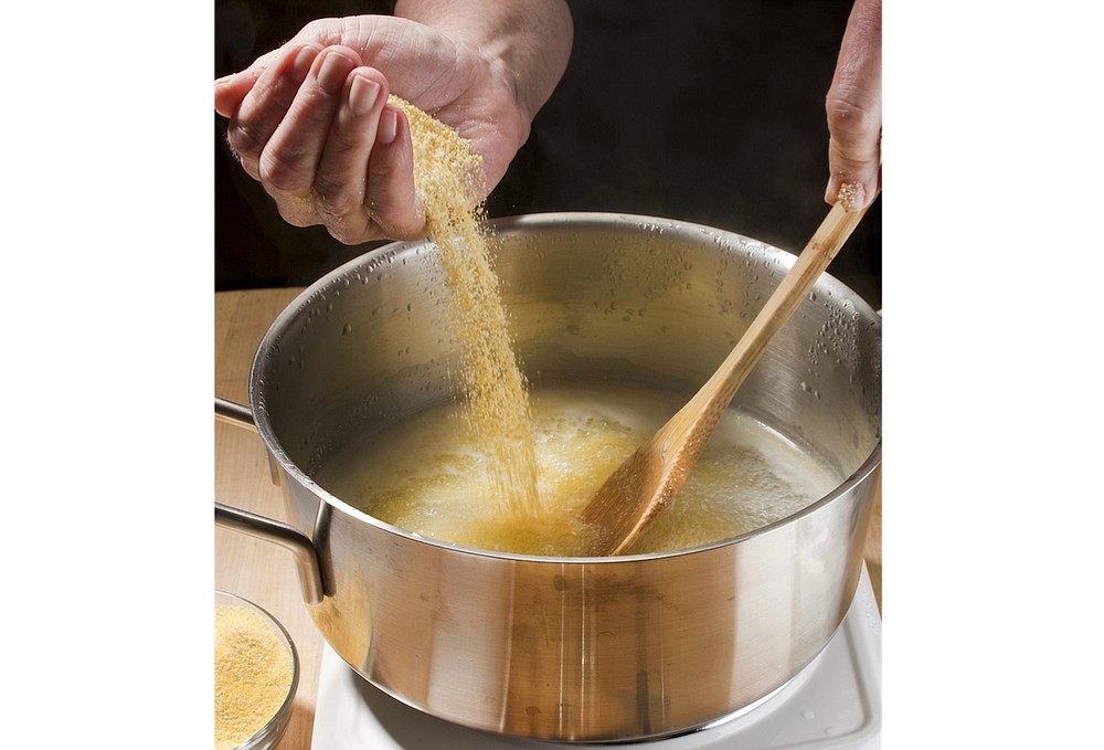 Pour in the polenta in a slow, steady stream, stirring all the while. (TNS/Chicago Tribune/Bill Hogan)