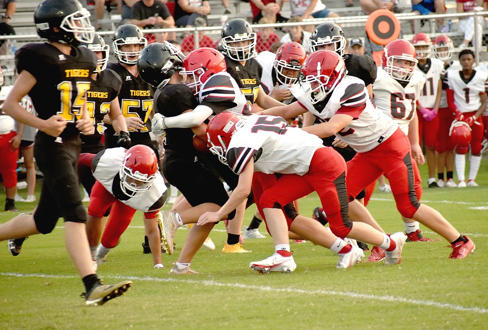 MARK HUMPHREY ENTERPRISE-LEADER/Farmington middle linebacker Morgan Schader lowers the boom on a Prairie Grove ball carrier during Thursday's junior high clash in the "Battle of 62" football rivalry. The junior Cardinals won on the road at Prairie Grove, 24-22.