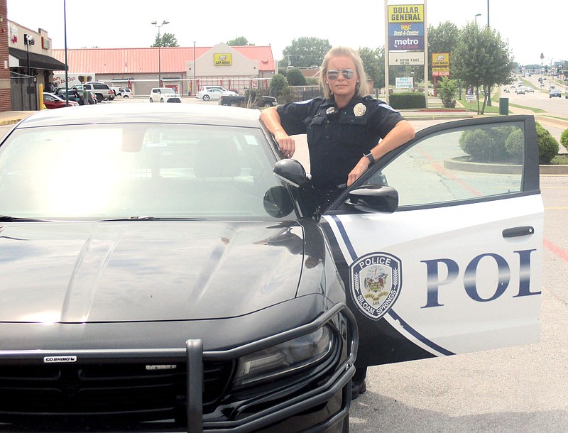 Marc Hayot/Herald Leader Officer DeAndra Strickland poses with her police cruiser. Since the schools shut down because of the coronavirus pandemic she has been working patrol.