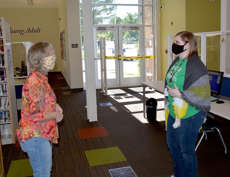 Marc Hayot/Herald Leader Dolores Deuel and Leah Humphrey discuss an upcoming library event.