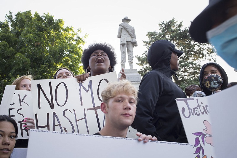 Protestors hold signs and chant, Monday during a protest rally against police brutality at the Bentonville downtown square in Bentonville. Check out nwaonline.com/200615Daily/ for today's photo gallery. 
(NWA Democrat-Gazette/Charlie Kaijo)