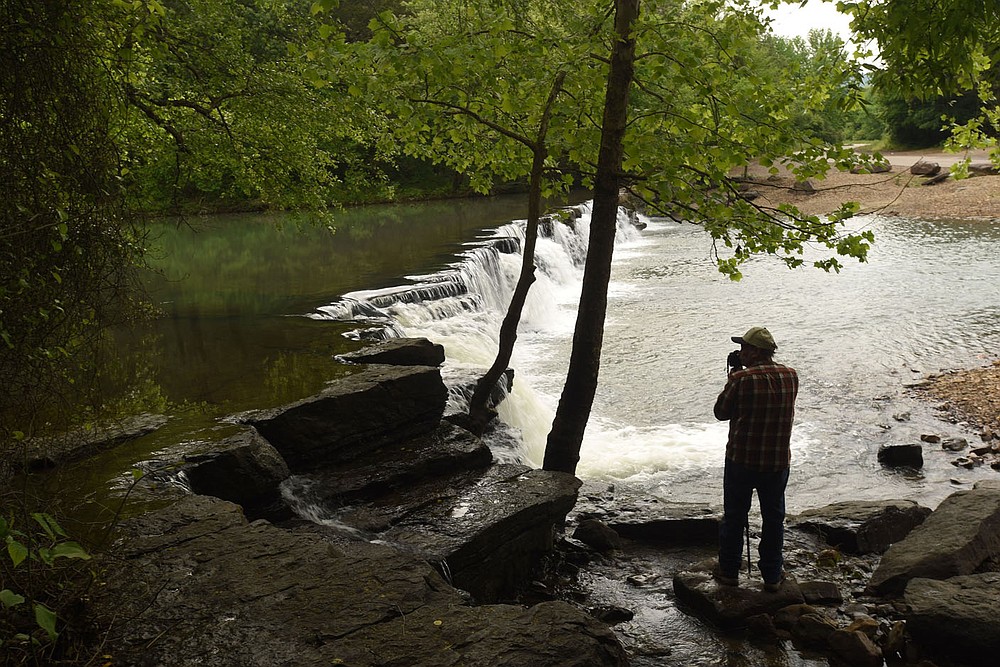 Terry Stanfill of the Decatur area takes in the sights and sounds of the Natural Dam waterfall.
(NWA Democrat-Gazette/Flip Putthoff)
