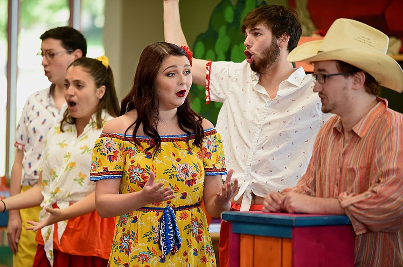 NWA Democrat-Gazette/DAVID GOTTSCHALK Jordan Knapick (center), with the Studio Artists of Opera in the Ozarks, performs as Maria Thursday, July 11, 2019, in the children's opera Monkey See, Monkey Do at the Springdale Library. Children in the audience received an opera related activity book. The artists will perform at the Bentonville Public Library on Saturday, July 13th at 2:00 p.m..