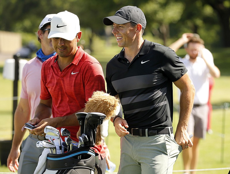 Rory McIlroy, right, smiles during practice for the Charles Schwab Challenge golf tournament at the Colonial Country Club in Fort Worth, Texas, Tuesday, June 9, 2020. The Challenge is the first PGA tour event since the COVID-19 pandemic began. (Tom Fox/The Dallas Morning News via AP)