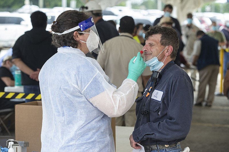 Heather Butler, a nurse with Tyson Foods, tests employee Kenneth Shrum Tuesday at a covid-19 testing station set up outside the Tyson Foods Chick-N-Quick plant in Rogers. Go to nwaonline.com/200610Daily/ to see more photos.
(NWA Democrat-Gazette/Ben Goff)