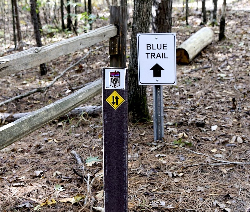 A file photo of signs guiding cyclists on the Northwoods Trails system. - Photo by Grace Brown of The Sentinel-Record